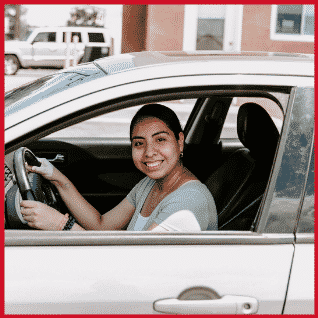 diana smiling in her car