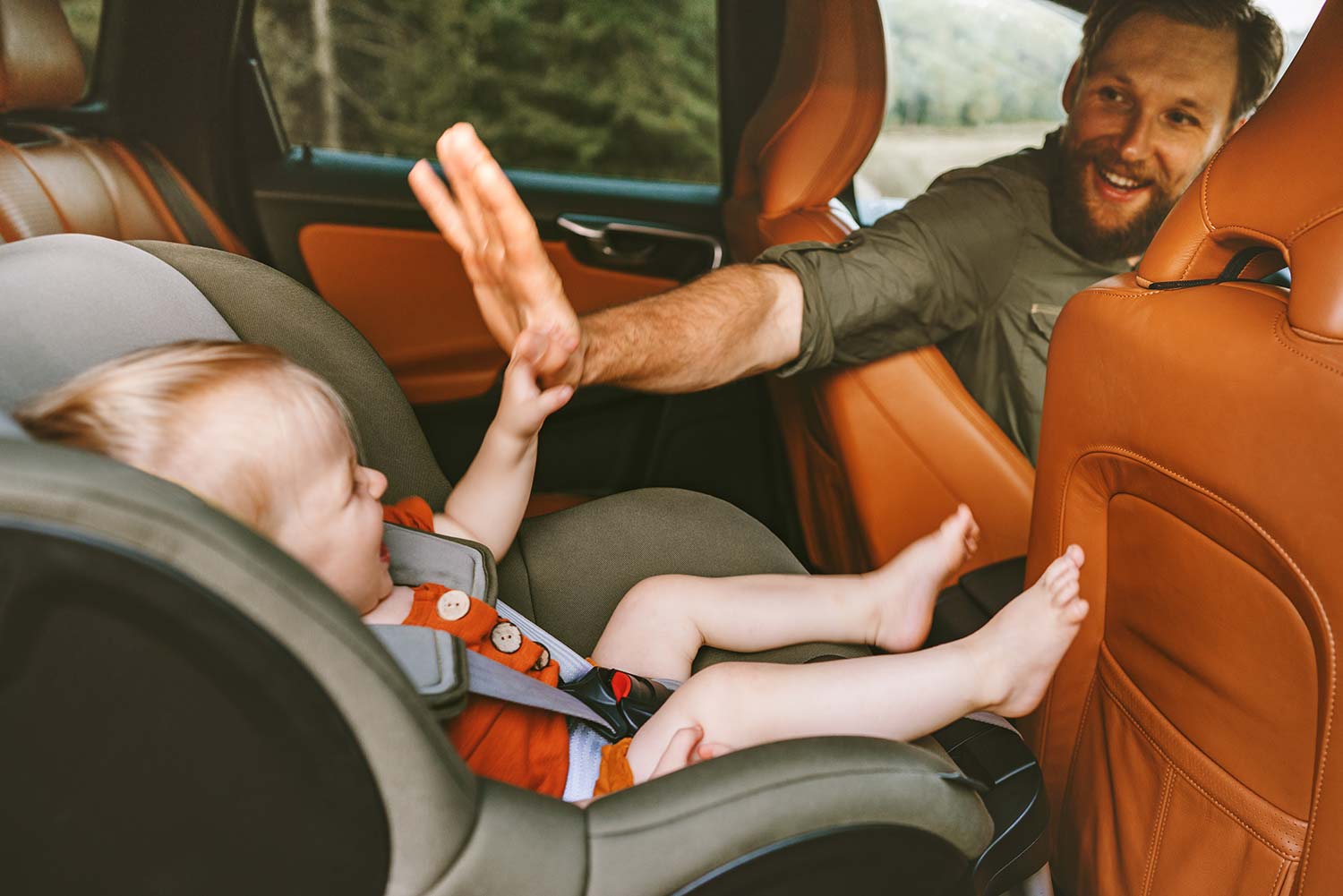 Father with child in car on road trip
