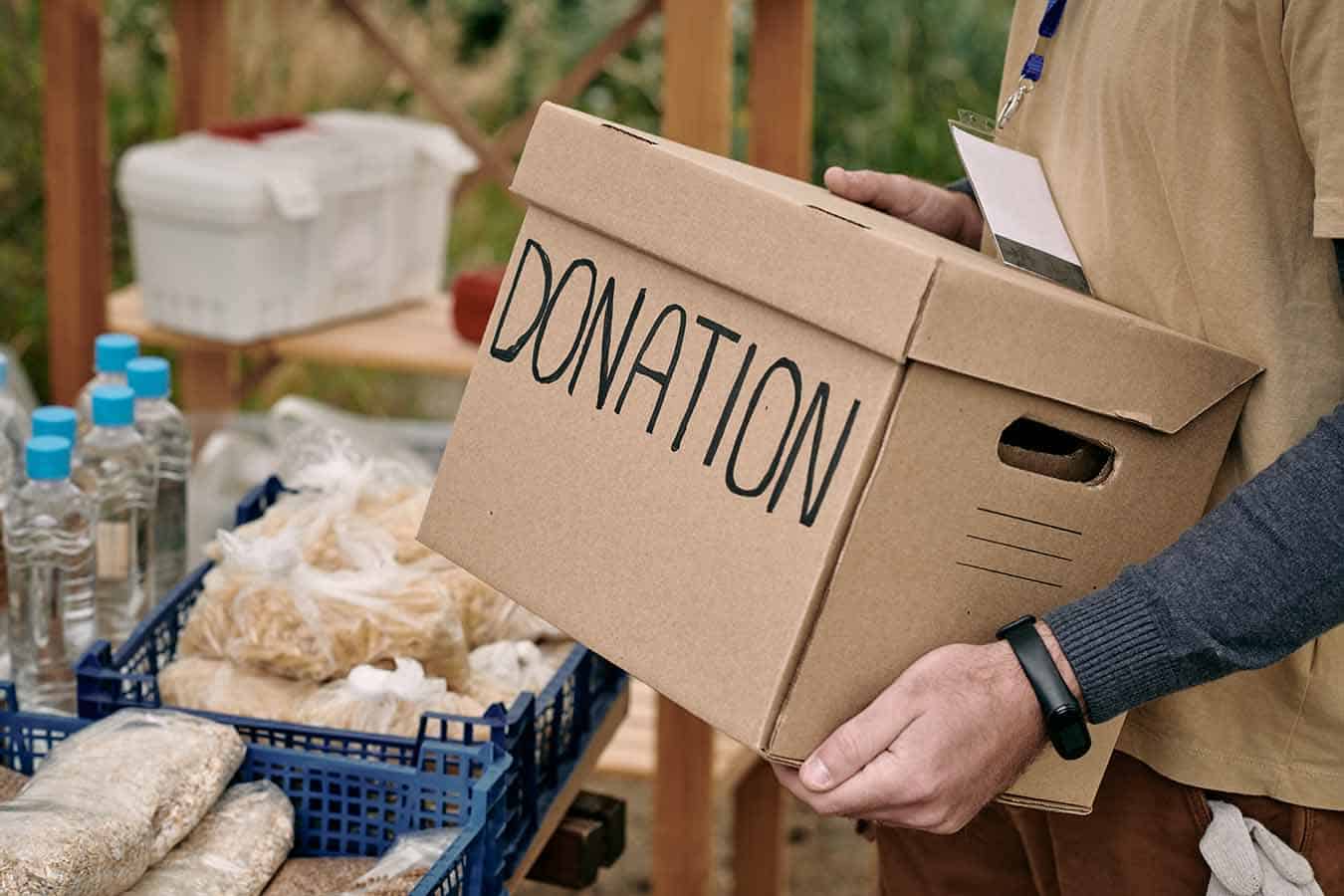 volunteer holding packed donation box