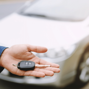 hand giving car key