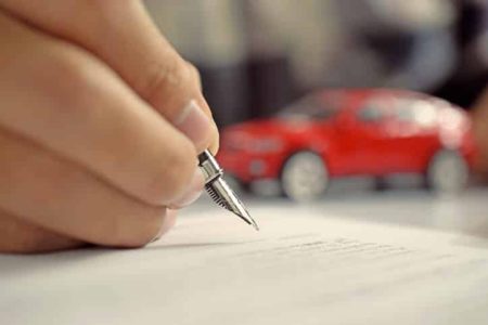 Man signing insurance document with signature. New or Used Car. Vehicle